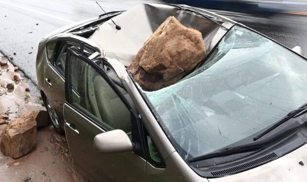 Man Escapes Death After Huge Rock Crushes His Car After He Stepped Out To Take A Phone Call (Photo)