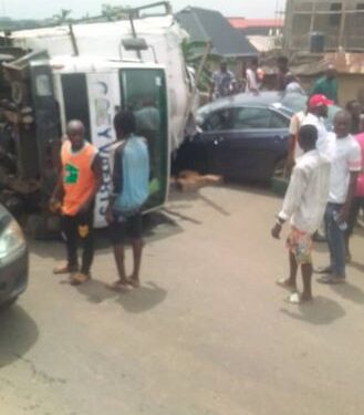 Driver Loses Consciousness After His Truck Falls On Car In Lagos
