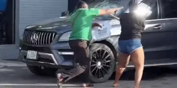 Lady smashes boyfriend’s windscreen after finding him with another woman (video)