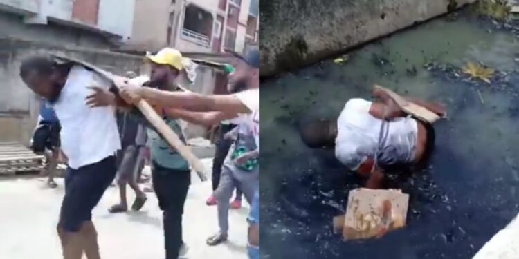 Outrage as man is tied up, beaten with bottles and planks before being thrown in gutter for allegedly being gay in Nigeria (video)