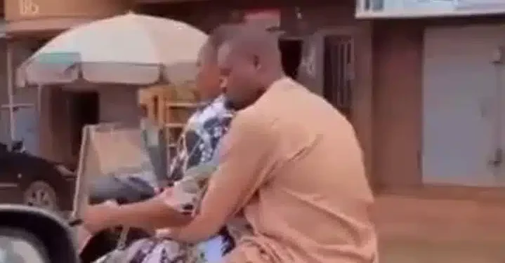 Man seen resting peacefully on his woman as she rides him on a bike (video)