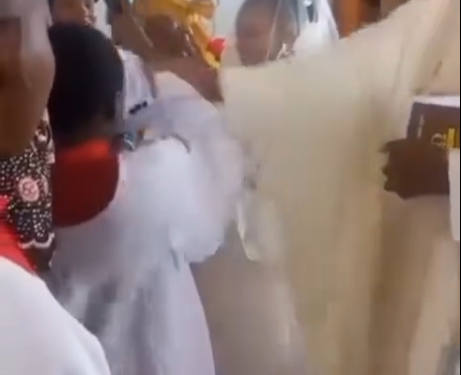 Priest gives altar boy a ‘heavy’ knock on the head for failing to keep the microphone steady as a groom and his bride exchanged vows